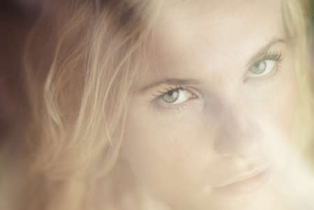 portrait of a beautiful girl behind the glassの写真素材
