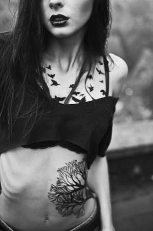 beautiful girl with a tattoo of birdsの写真素材