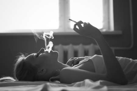 face beautiful girl smoking a cigaretteの写真素材