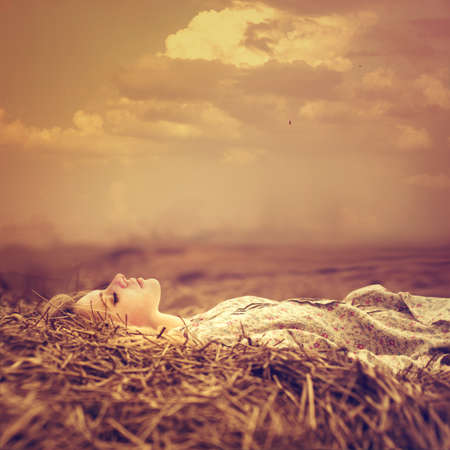 beautiful blonde is in a magical place in the meadowの写真素材