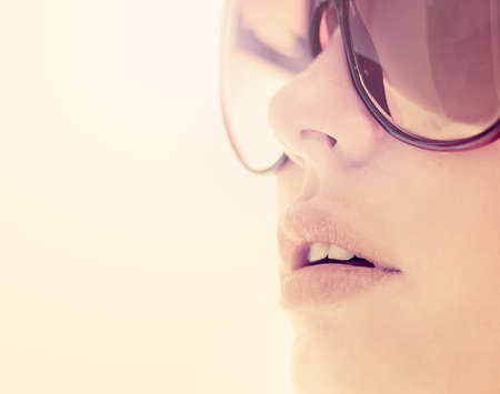 young beautiful woman in glasses outdoorsの写真素材