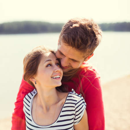 happy young couple walking on the beachの写真素材