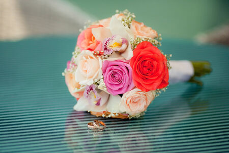 Pastel wedding bouquet with roses on blue glass tableの写真素材