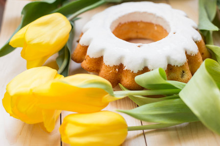 Easter cake and bunch of  yellow tulips