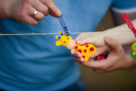 Giraffe soft toy in hands on pin