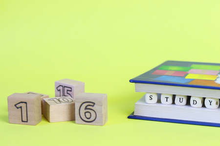 The word learning from letters written on wooden cubes. Defocused numbers. Copy space - concept of education, child development, back to schoolの写真素材