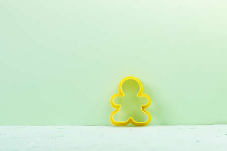 A baking dish in the form of a man on a light green background. Copy space - cooking concept, pastry...