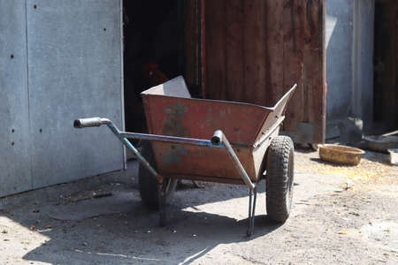 Construction truck near the barn. A bowl of chicken feed. Copy space - concept of village, agriculture, yard, labor, summer.の写真素材
