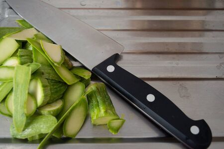 Zucchini skin peeled with a knife. In a handful