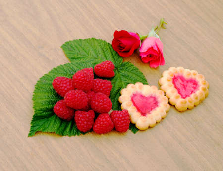 biscuits in a box, nectarines and a bouquet of rosesの写真素材