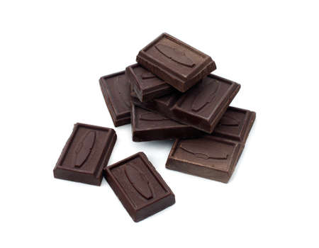 pieces of dark chocolate are on a white background