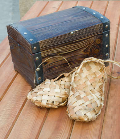Russian bast shoes standing on the wooden floorの写真素材