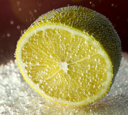 lemon floating in soda waterの写真素材