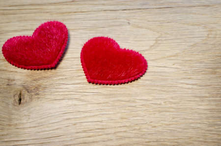 Red fluffy hearts are on  oak planksの写真素材