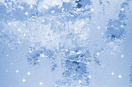 Frost patterns on window. Festive bokeh background
