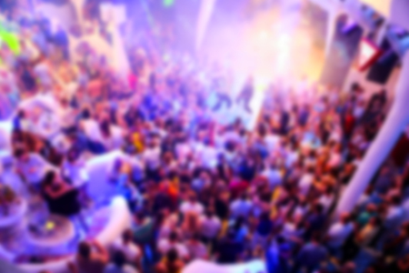 Blurry night club dj party people enjoy of music dancing sound with colorful light. club night light...