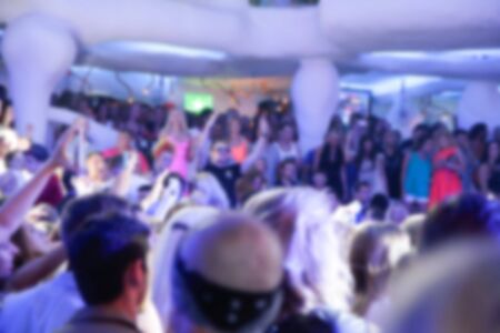 Blurry night club dj party people enjoy of music dancing sound with colorful light. club night light dj party Ibiza club. With Smoke Machine and lights. Dark background.の写真素材