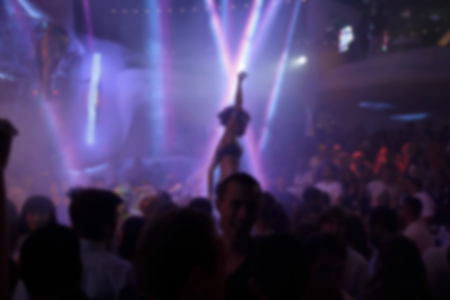 Blurry night club dj party people enjoy of music dancing sound with colorful light. club night light dj party Ibiza club. With Smoke Machine and lights. Dark background.の写真素材