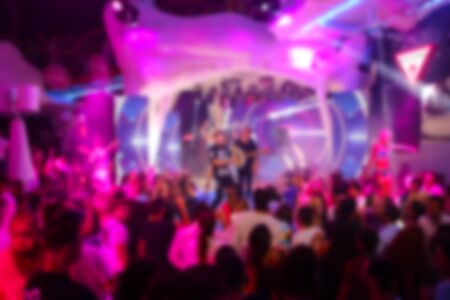 Blurry night club dj party people enjoy of music dancing sound with colorful light.の写真素材