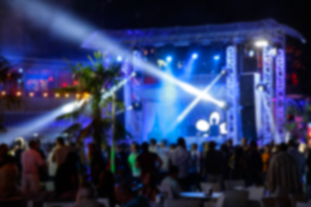 Blurry night club dj party people enjoy of music dancing sound with colorful light. club night light dj party Ibiza club. With Smoke Machine and lights. Dark background.の写真素材