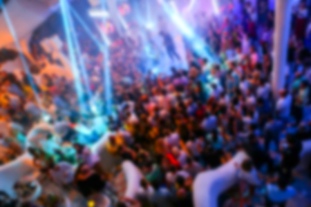 Blurry night club dj party people enjoy of music dancing sound with colorful light.の写真素材