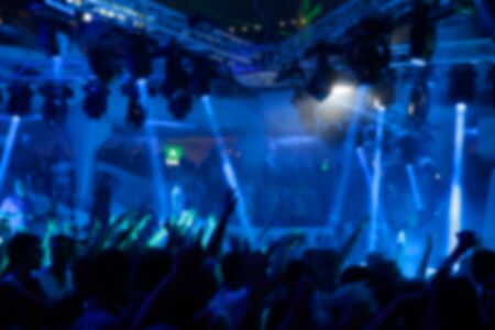 Blurry night club dj party people enjoy of music dancing sound with colorful light. club night light dj party Ibiza club. With Smoke Machine and lights. Dark background.の写真素材
