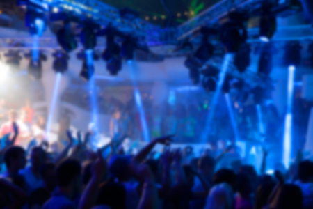 Blurry night club dj party people enjoy of music dancing sound with colorful light. Machine and lights. Dark background.の写真素材