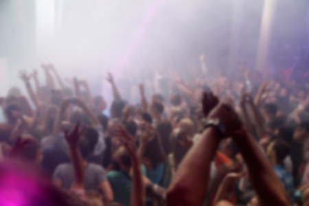 Blurry night club dj party people enjoy of music dancing sound with colorful light. club night light dj party Ibiza club. With Smoke Machine and lights. Dark background.の写真素材