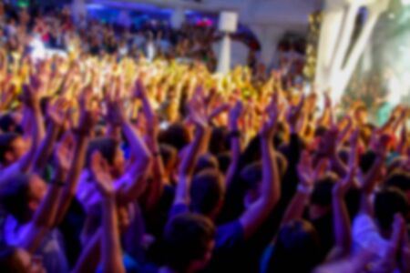 Blurry night club dj party people enjoy of music dancing sound with colorful light. club night light dj party Ibiza club. With Smoke Machine and lights. Dark background.の写真素材