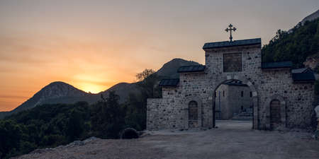 Sunset over the gate of Orthodox Monastery in mountains, Budva, Montenegroの写真素材
