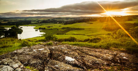 Sunset over Scottish fieldsの写真素材