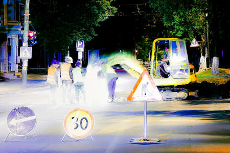 abstract photo of road repair, 4 workers repairing the roadの写真素材