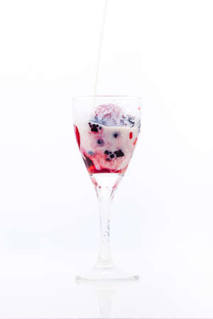 milk poured on berries in a glass on a white background, raspberry, strawberry, strawberryの写真素材