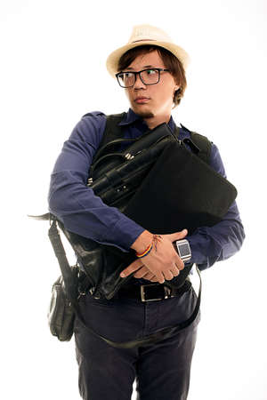 studio portrait of Man in glasses on a white background, a lost tourist hugging bags and looking awayの写真素材