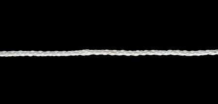 Close up of a white rope on black backgroundの写真素材