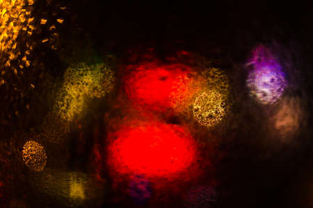 Colorful defocused bokeh lights background. City glare abstract background.の写真素材