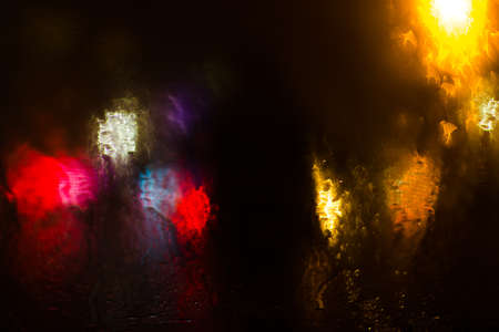 Colorful defocused bokeh lights background. City glare abstract background.の写真素材