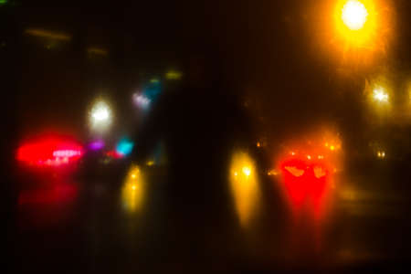 Colorful defocused bokeh lights background. City glare abstract background.の写真素材