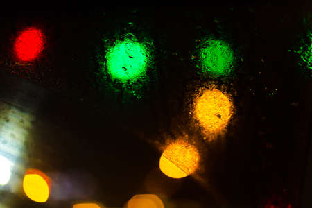 Colorful defocused bokeh lights background. City glare abstract background.