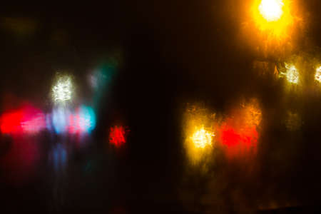 Colorful defocused bokeh lights background. City glare abstract background.