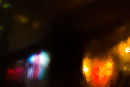 Colorful defocused bokeh lights background. City glare abstract background.の写真素材
