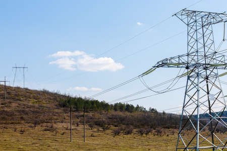 high voltage electric power lines on pylons, power transmission towerの写真素材