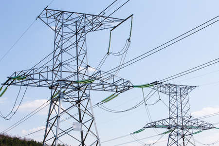 high voltage electric power lines on pylons, power transmission towerの写真素材