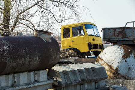 yellow damaged, rusted truck on the dump, backgroundの写真素材