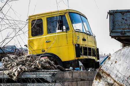 yellow damaged, rusted truck on the dump, backgroundの写真素材