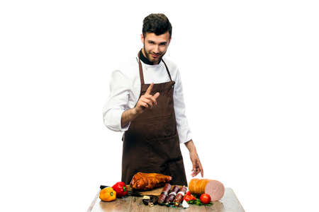 young cheaf with salami on the table, isolated on white backgroundの写真素材