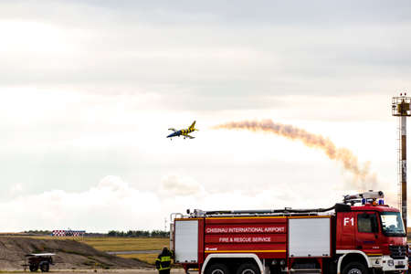 avia show 25.09.2016 Moldova. International Moldavian airport air show on the occasion of national day of Civil Aviation. Aerial acrobatics over fire engineのeditorial素材