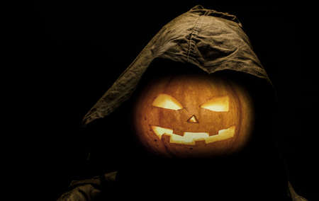 symbol of halloween, scarry jack pumpkin in the hood, backgroundの写真素材