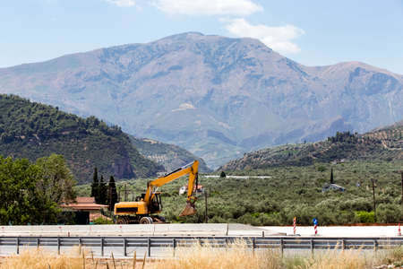 photo of excavator in the mountains of Greece in sunny summer dayの写真素材