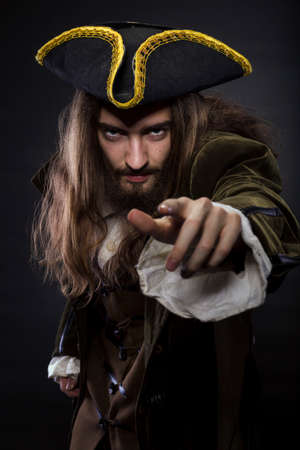 portrait of bearded and hairy pirate pointing into the viewer, shallow DOF